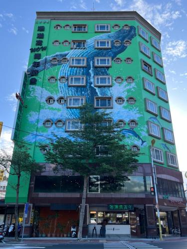 a building with a painting on the side of it at Hualien Wow Hostel in Hualien City