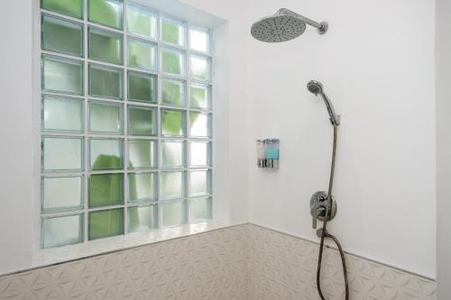 a shower in a bathroom with a window at Chaweng Boho Modern in Ban Ko Khwan