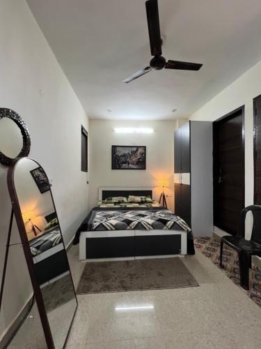 a bedroom with a bed and a ceiling fan at The Cozy Nest in Gurgaon