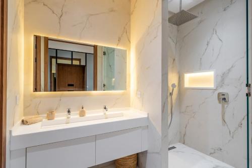 a bathroom with a white sink and a mirror at Villa Capella heated pool and cooker in Marrakesh