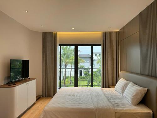 a bedroom with a large bed and a television at V3K05A Sonasea Vân Đồn in Quang Ninh