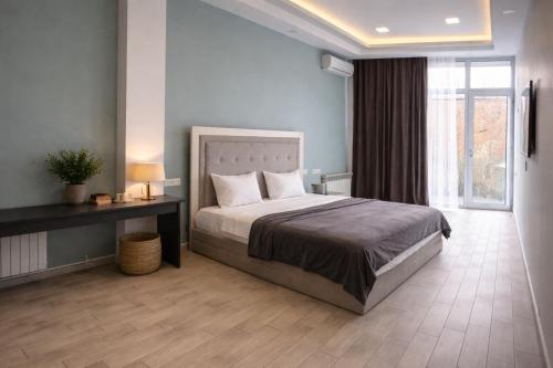 a bedroom with a large bed and a window at Wave Inn boutique in Yerevan