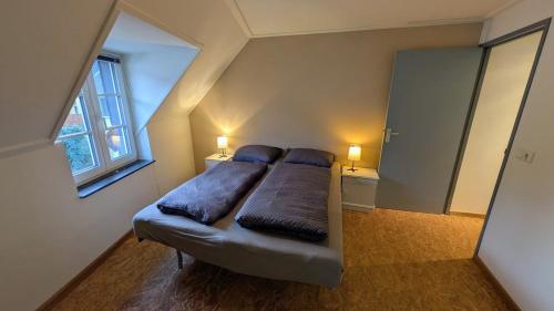 a bedroom with a bed with two pillows on it at Mosel-Cottage-Appartment in Briedern