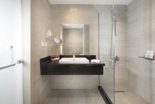 a bathroom with a sink and a shower at Pyramisa Hotel Luxor in Luxor