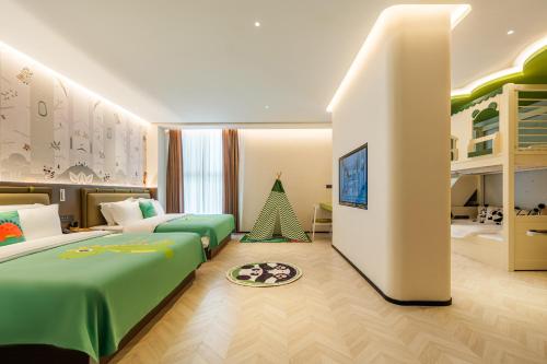 a childrens bedroom with two beds and a tv at Panda Sleepy Hotel（Chengdu Panda Base) in Chengdu