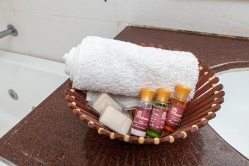 a basket filled with soap and toothpaste on a counter at La Comfort By shrpl in Gurgaon