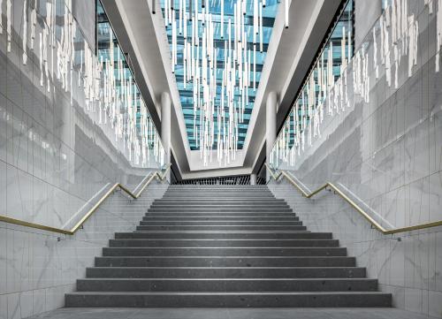 a staircase in a building with escalators andwindows at Clarion Congress Hotel Brno in Brno