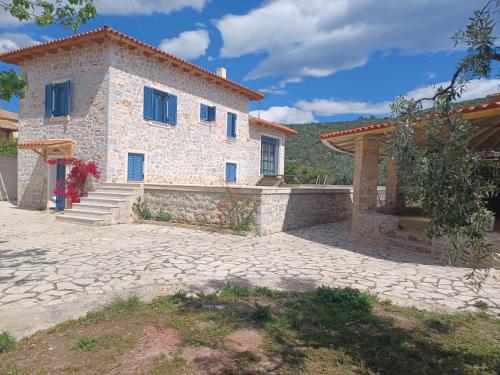 a large stone house with a stone driveway at villa olivedream in Nea Epidavros
