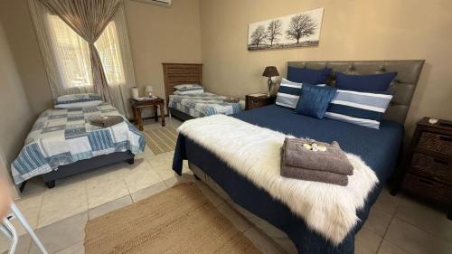 a bedroom with two beds with blue and white at Marzel Guesthouse - Room 2 in Britstown