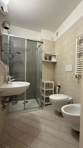 a bathroom with a shower and a sink and a toilet at Iris Chioggia in Chioggia