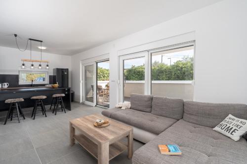 a living room with a couch and a table at Premium Apartment Obatnice with Pool in Povljana