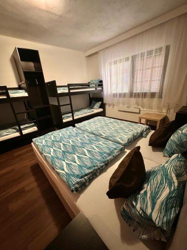 a bedroom with two beds and a window in it at Penzion Black Hole in Provodín