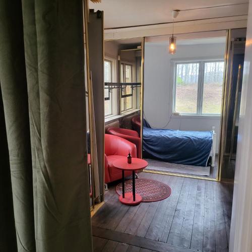 a living room with a red table and a couch at Safety System Show Jumps in Enköping