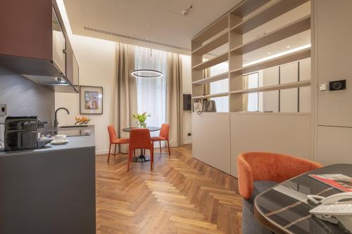 a kitchen and dining room with a table and chairs at Hotel Pierre Milano in Milan