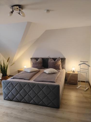 a bedroom with a large bed with two pillows at FW zur Gemütlichkeit in Hirschaid