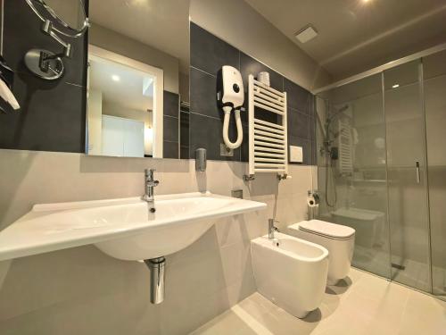 a bathroom with a sink and a toilet at La Dolce Vita Hotel in Menton