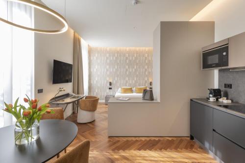 a kitchen and living room with a table and chairs at Hotel Pierre Milano in Milan