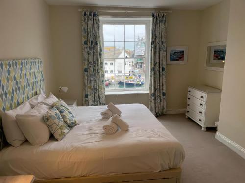 a bedroom with a bed with two teddy bears on it at Safe Harbour in Weymouth