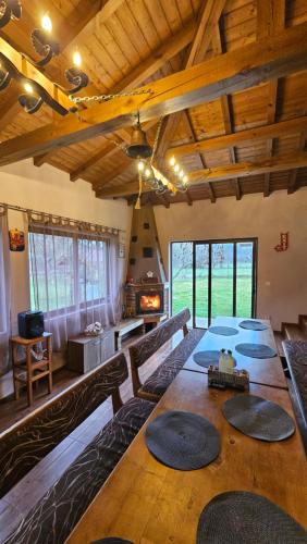 a large room with a table and a fireplace at Къща за гости Ореха in Apriltsi