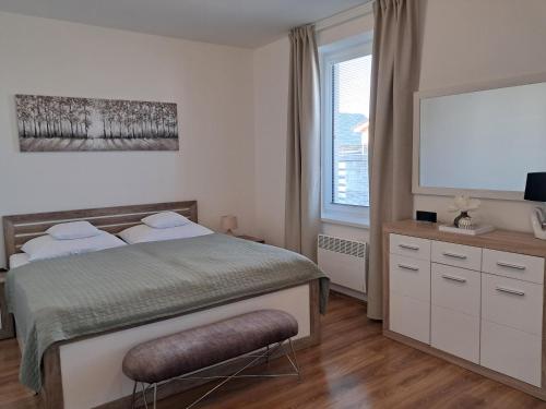 a bedroom with a bed and a large window at Apartmany Rubin Nesvady in Nesvady