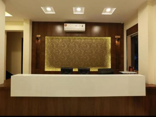 a lobby with a reception desk with chairs in it at Hotel Anchal Villa By YB Hotel in Udaipur