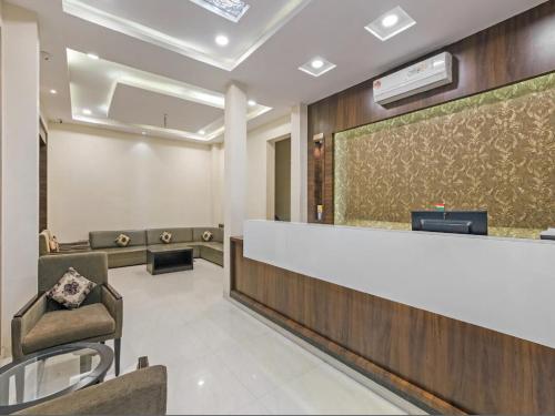 a waiting room with a reception counter and chairs at Hotel Anchal Villa By YB Hotel in Udaipur