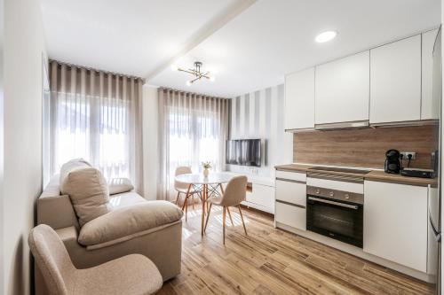 a kitchen with a couch and a chair and a table at Polán Living | New Apartment - B in Polán