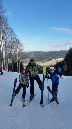 a group of people standing in the snow with skis at Apartma Panorama Jeseník in Jeseník