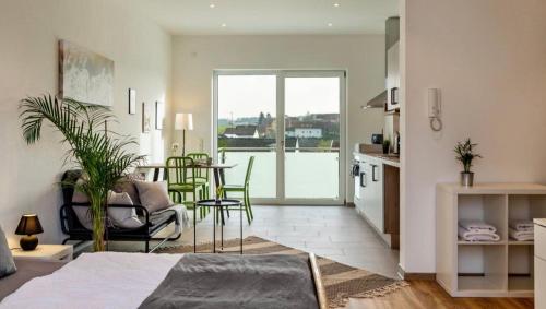 a kitchen and living room with a table and chairs at Mina in Geratskirchen
