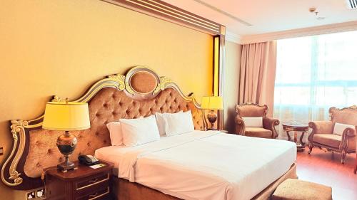 a hotel room with a bed with a mirror above it at Sunday Hotel Al Barsha Dubai Mall of the Emirates Formerly Grand Excelsior Al barsha in Dubai