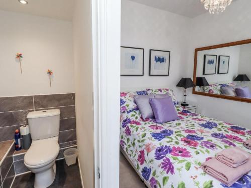 a bedroom with a bed and a toilet at Sea Mist in Newbiggin-by-the-Sea
