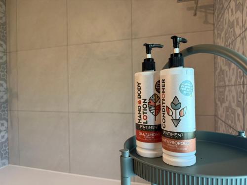 two bottles ofodorizers sitting on a shelf in a bathroom at Cyherbia Botanical Park & Labyrinth in Avgorou