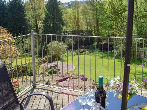 a table with a bottle of wine on top of a fence at Denham in Glaisdale