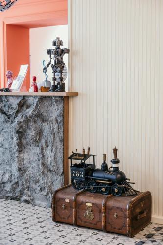 a train on top of a suitcase in a room at Artist hotel in Subotica
