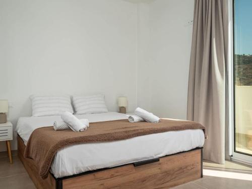 a bedroom with a bed with towels on it at Luxury 2 Bedrooms Apartment Bayview Hills Nerja in Torrox