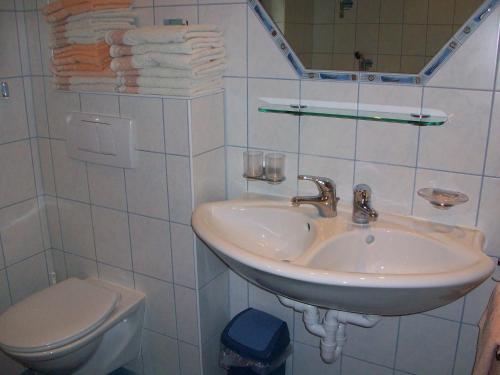 a white bathroom with a sink and a toilet at Gästehaus Flörl in Gerlosberg