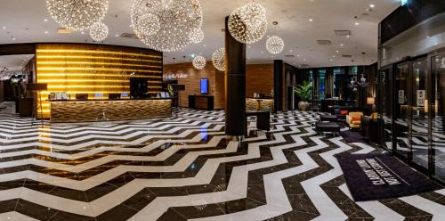 a lobby with a zebra patterned floor at Clarion Hotel Aviapolis in Vantaa