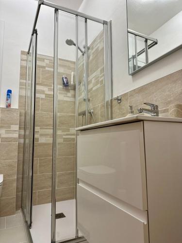 a glass shower in a bathroom with a sink at Da Nonna Laura in Follina