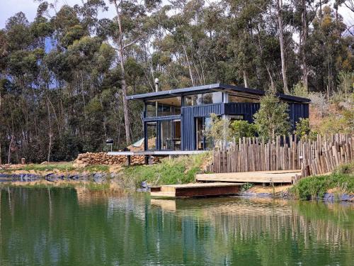 a house on the shore of a body of water at Camissa Farm in Stellenbosch