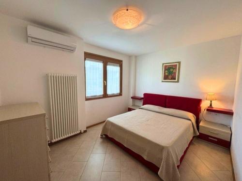 a bedroom with a large bed and a window at Appartamenti La Croma in Grado