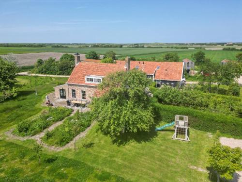 an aerial view of a house with a playground at Het Grote Huis at Buitenplaats Zeeuwse Liefde in Westkapelle