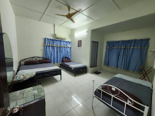 a living room with two beds and a couch at Raintown RR Homestay in Kamunting