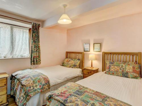 a bedroom with two beds and a window at Cleeve- Ukc4922 in Timberscombe