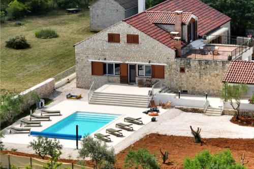 an aerial view of a house with a swimming pool at Villa Demare with Heated Pool, Free EVC Station in Lovinac