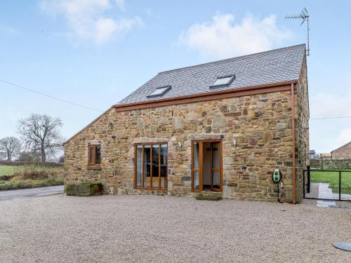 an old stone barn with a gravel driveway at Barn View in Clay Cross