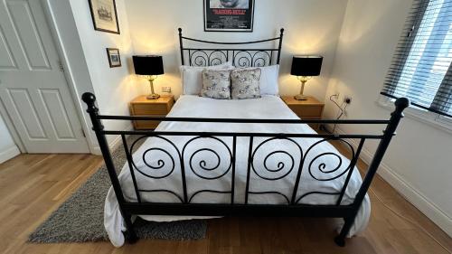 a black and white bed in a room with two lamps at Luxury Rooms - St Leonards on Sea - East Sussex in St. Leonards