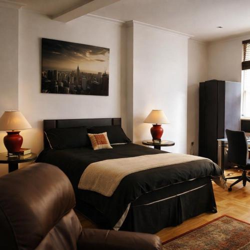 a bedroom with a large bed and a couch at Luxury Rooms - St Leonards on Sea - East Sussex in St. Leonards