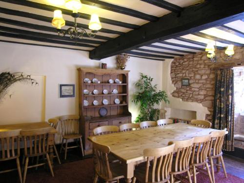 a dining room with a wooden table and chairs at West Wing- Ukc4914 in Timberscombe