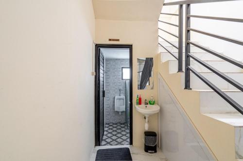 a bathroom with a sink and a toilet at Spacious Tropical Villa with Pool and Bfast in Sleman