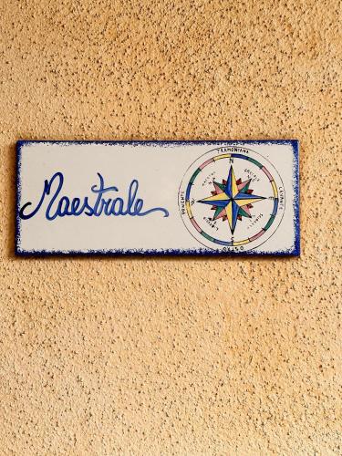 a sign on a wall with the name of nostalgia at Crisalide in La Maddalena